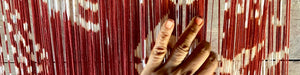 red ikat loom with weavers hand in Sumba Indonesia